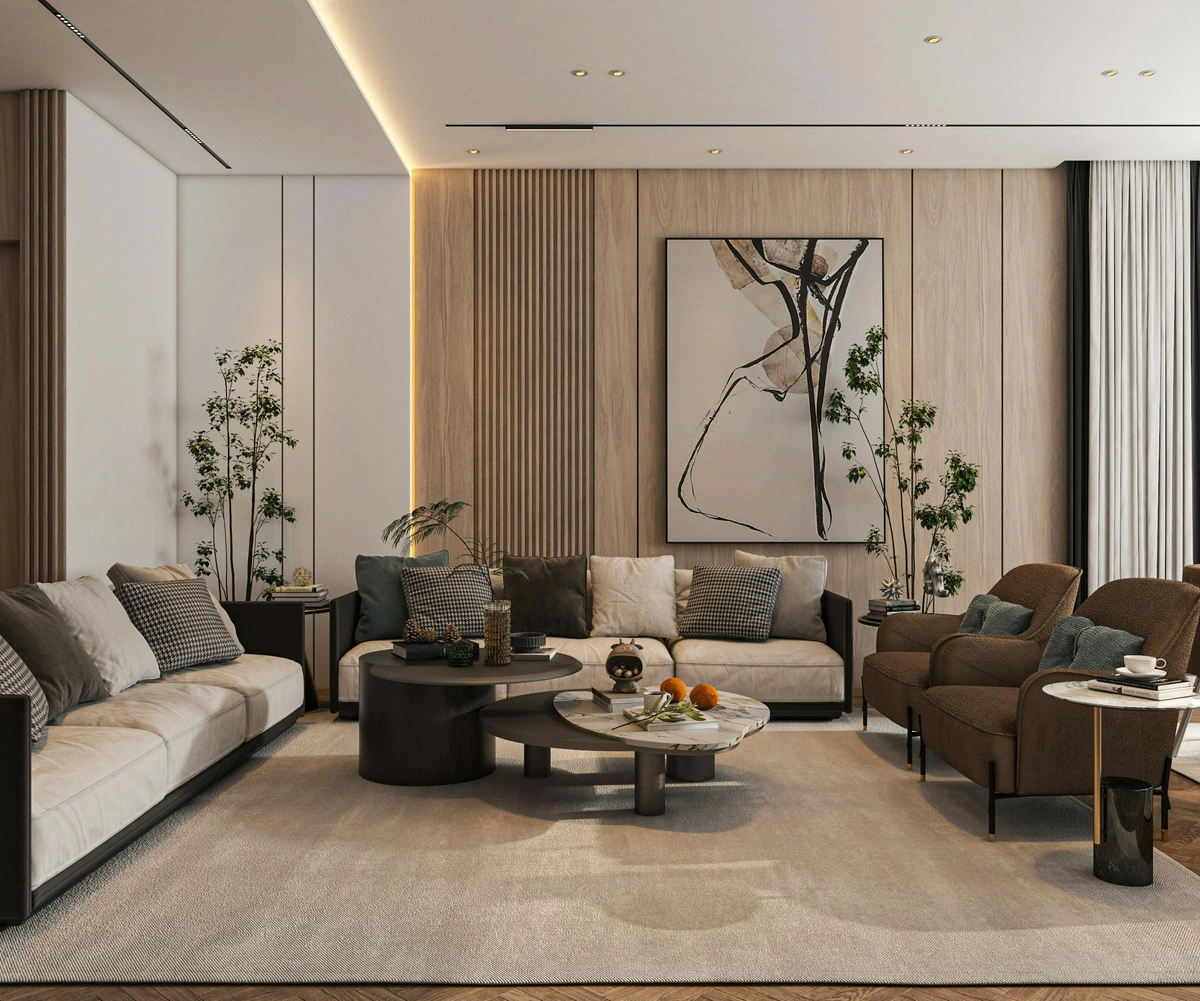 Spacious modern living room with neutral tones, featuring two sofas, armchairs, layered coffee tables, and abstract artwork on a wood-paneled wall.