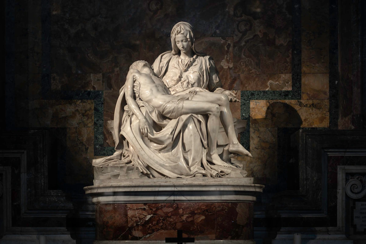 Michelangelo's Pietà sculpture, a marble masterpiece of Renaissance art depicting Mary holding the body of Jesus with serene sorrow.
