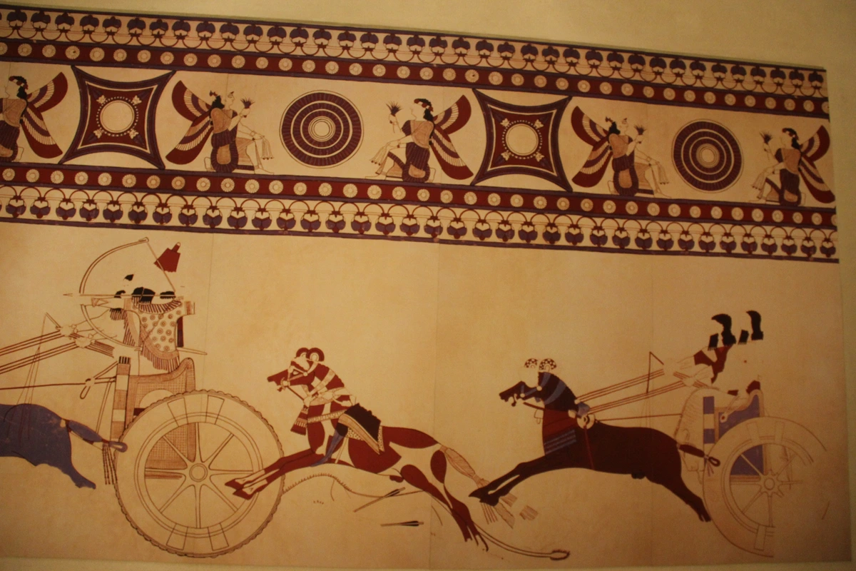 Ancient Near East fresco depicting a chariot race with figures in elaborate attire and decorative borders.