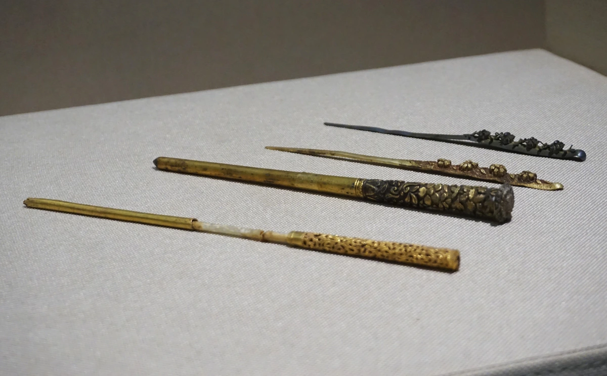 Four gilded hairpins from the Southern Song Dynasty, showcasing intricate floral and patterned designs.