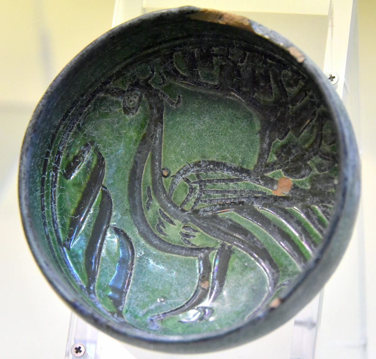 Schaal versierd met de sgraffitotechniek, met een vogelmotief met groene onderglazuur.