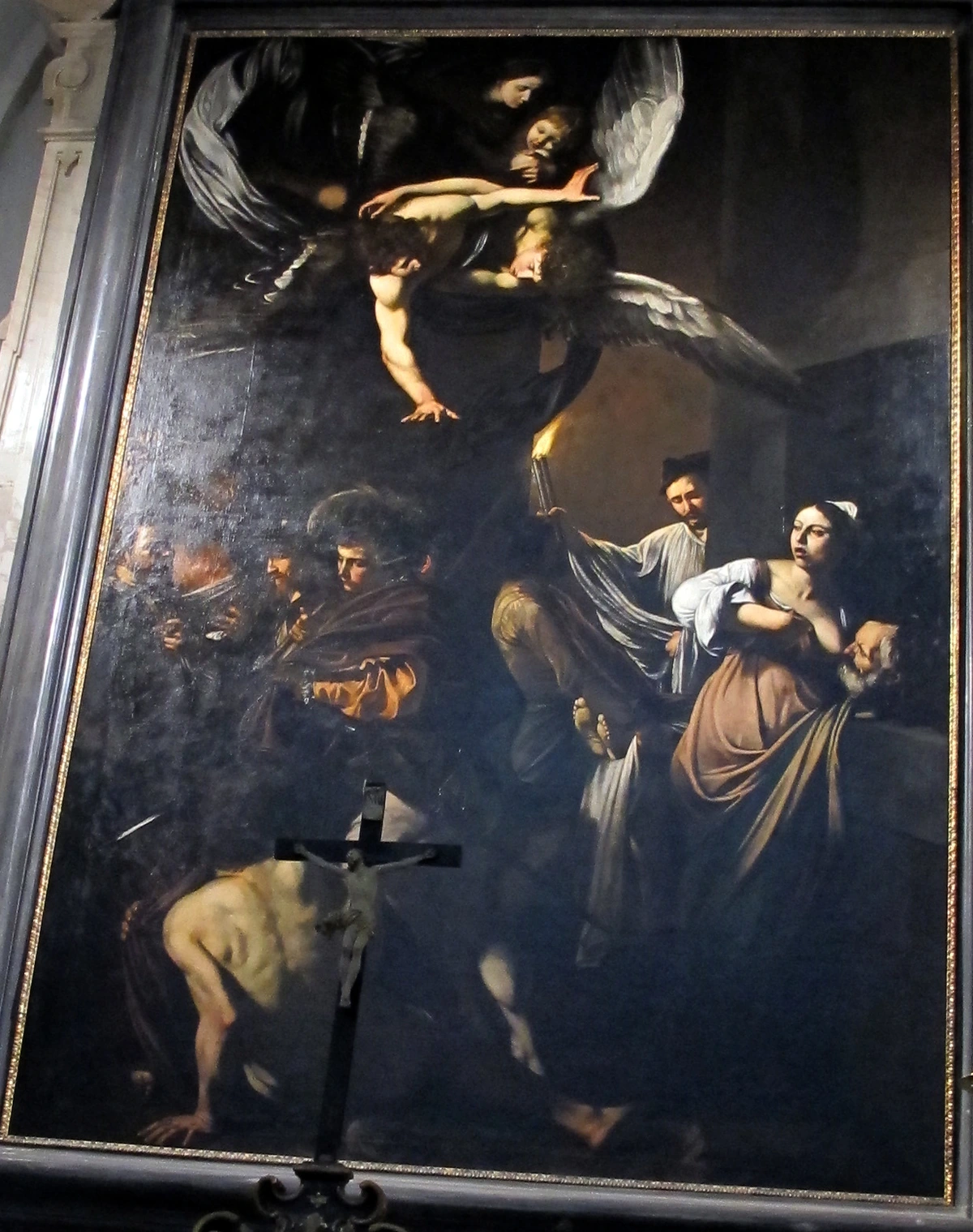 Caravaggio's 'Seven Works of Mercy' painting, showcasing dramatic tenebrism with stark contrasts between light and shadow.